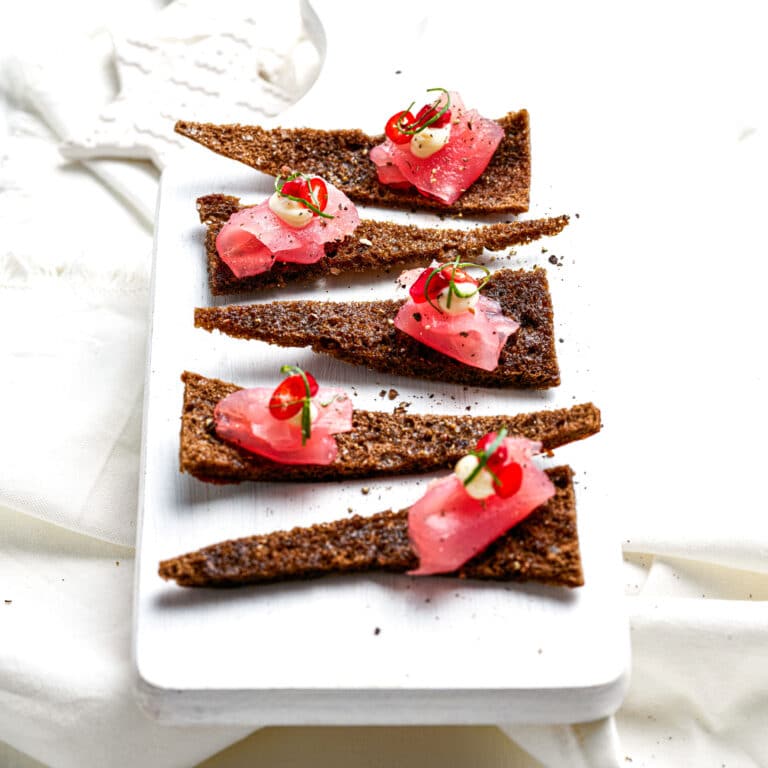 TUNA CRUDO ON RYE-POMEGRANATE WAFERS