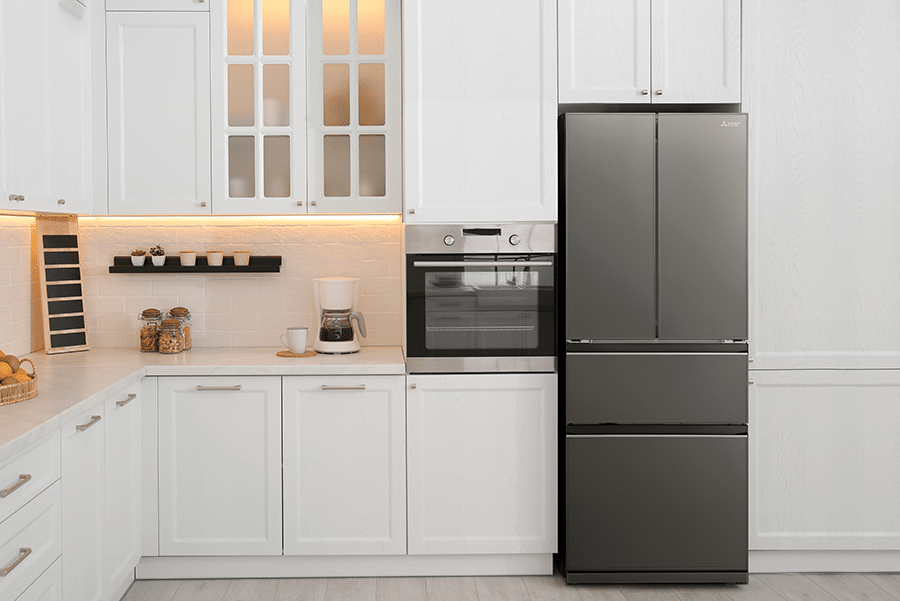 Modern white kitchen featuring Mitsubishi Electric MR-LX442EX dark stainless steel French door refrigerator and built-in oven, showcasing sleek design with clean lines, under-cabinet lighting, and contemporary home appliances