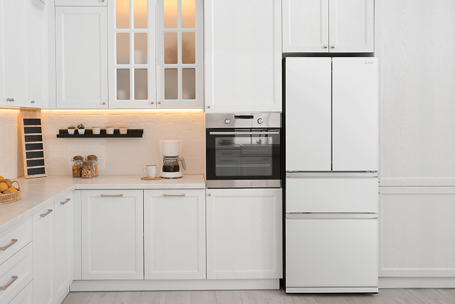 Modern white kitchen featuring Mitsubishi Electric MR-LX442EX white French door refrigerator and built-in oven, showcasing sleek design with clean lines, under-cabinet lighting, and contemporary home appliances