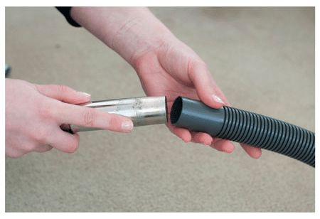 The Mitsubishi Electric Quick Clean Kit vacuum cleaner tube is attached to the universal adapter.